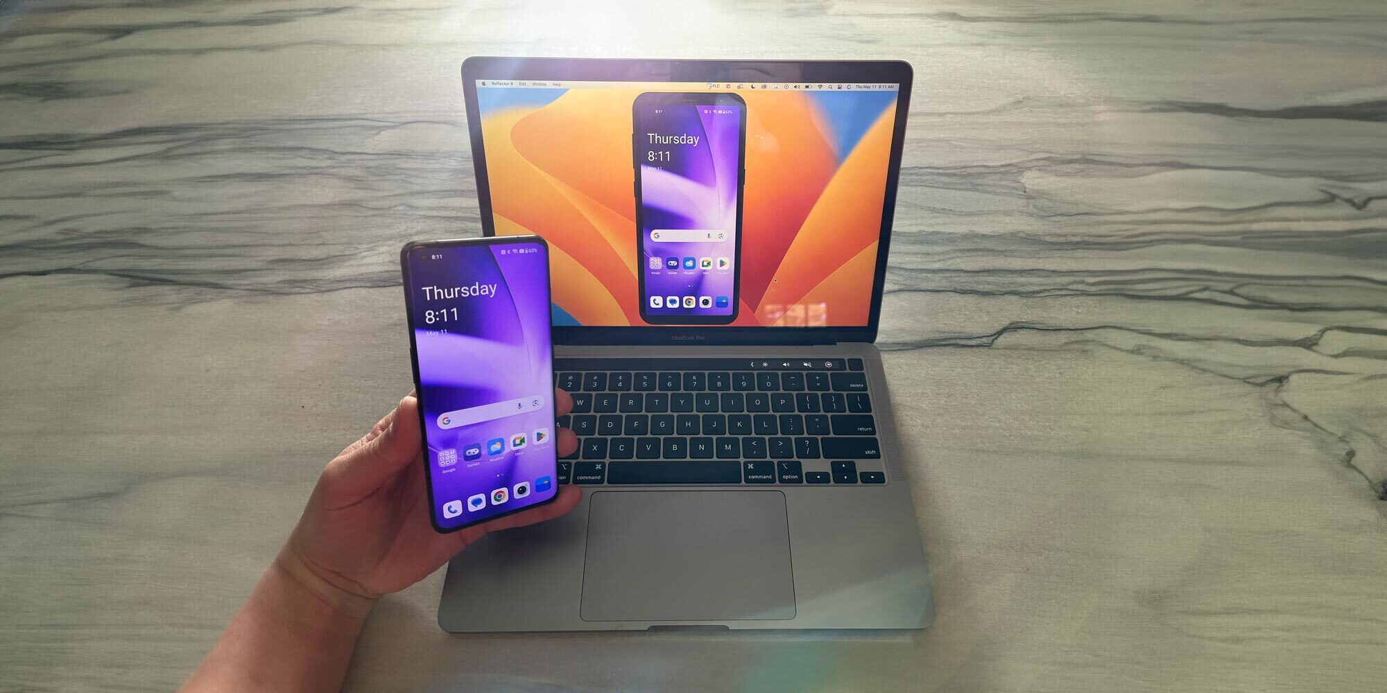 OnePlus 11 phone mirrored to a MacBook