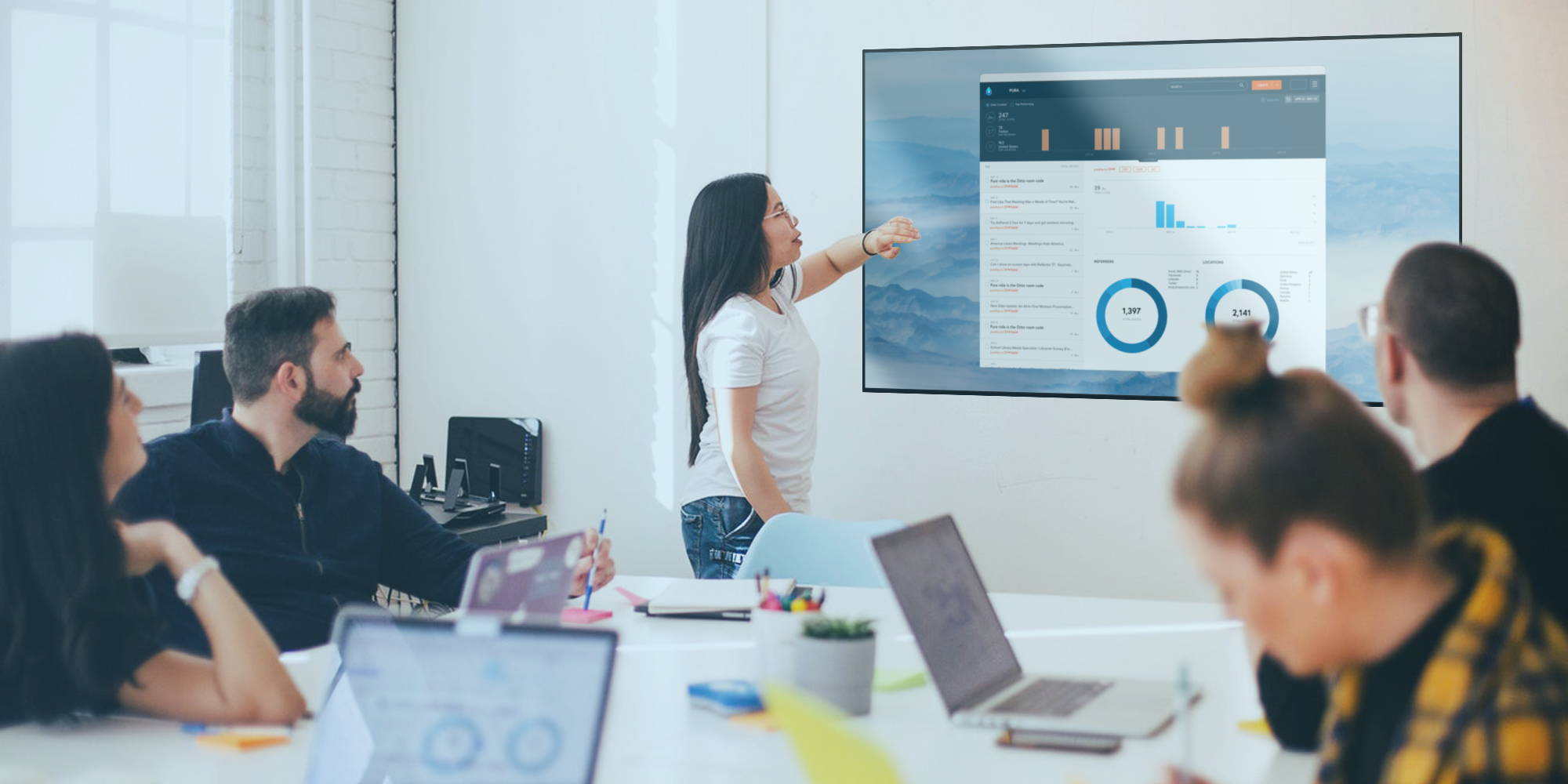 Woman presenting wirelessly in conference room