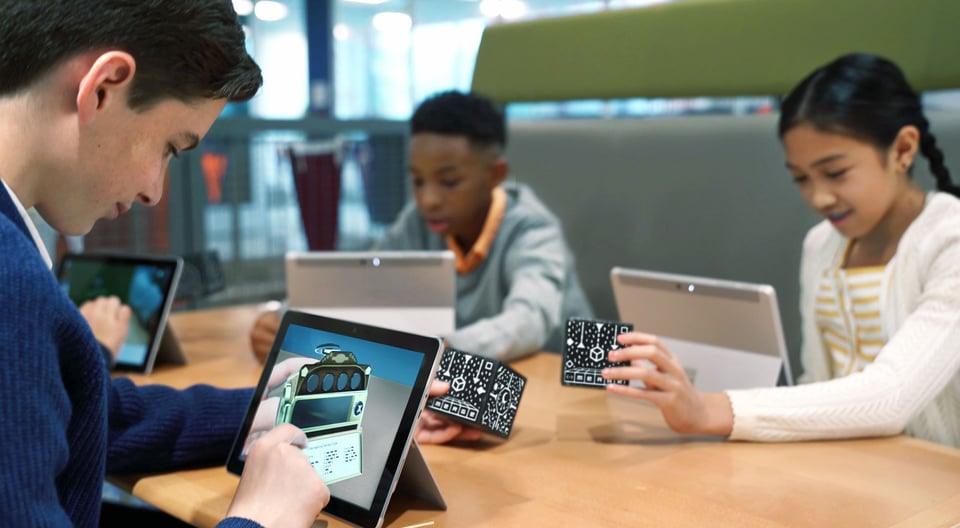 Students using Merge Cube on computers