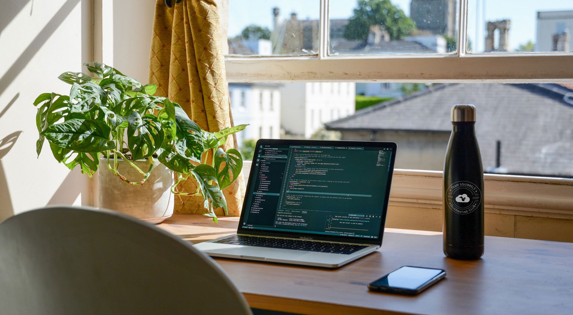 Desk with computer and water bottle working from home